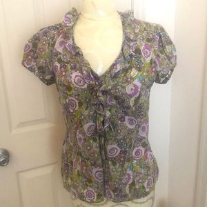 Short sleeve blouse; floral design of muted greens and violet